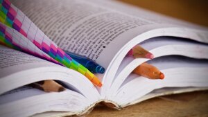 Buch mit mehreren Stiften als Lesezeichen